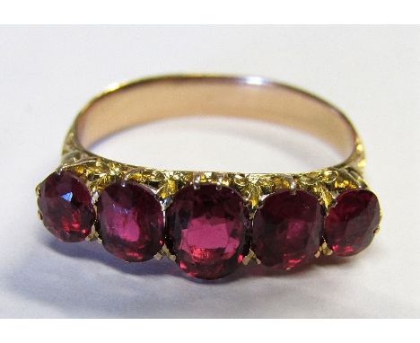 A ruby ring set with five graduated oval cut stones in scrolled mount, size M, 3.1g