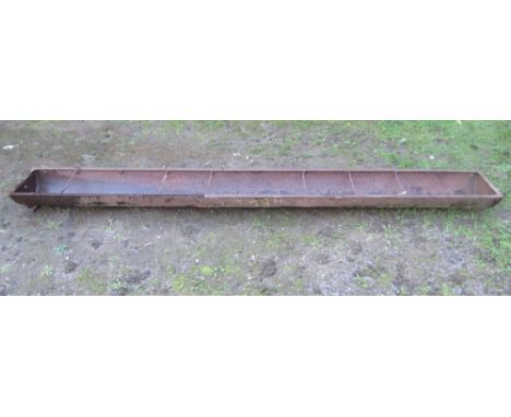 A vintage cast iron pig feeding trough with rung divisions, 304 cm long, together with one other galvanised example (2)