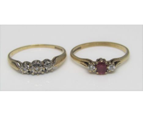 A 9ct diamond and ruby set ring, together with a further 9ct three stone diamond ring, both size N, 2.6g total