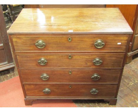 A Regency mahogany chest of four long graduated drawers, with original embossed brass lion mask handles, raised on bracket su