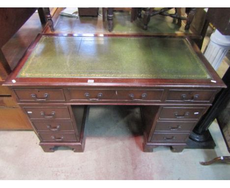 A reproduction Georgian style mahogany veneered kneehole twin pedestal writing desk of rectangular form with inset green leat