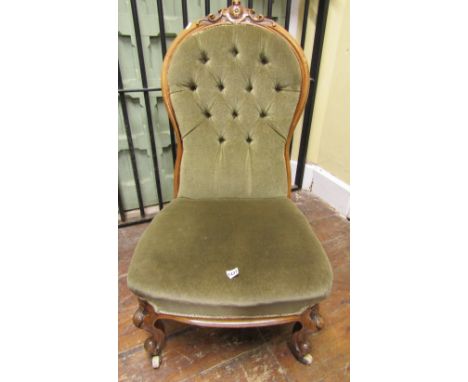 A mid-Victorian period spoon back drawing room chair with carved and moulded walnut show wood frame, the button back and seat