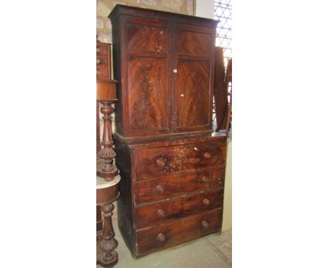 An early 19th century mahogany secretaire bookcase/cupboard, the lower chest section fitted with four long drawers, the upper