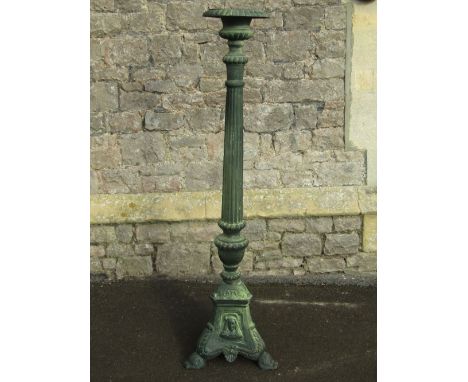 A reproduction cast iron floorstanding pricket candlestick/stand with partially fluted column and tricorn base with further d