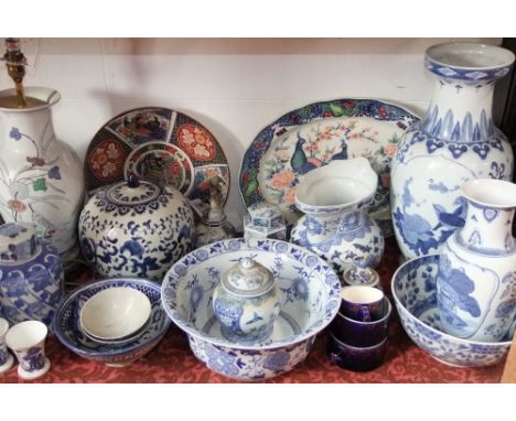 A quantity of reproduction oriental blue and white ceramics including two vases, a jug, vase and cover of globular shaped for