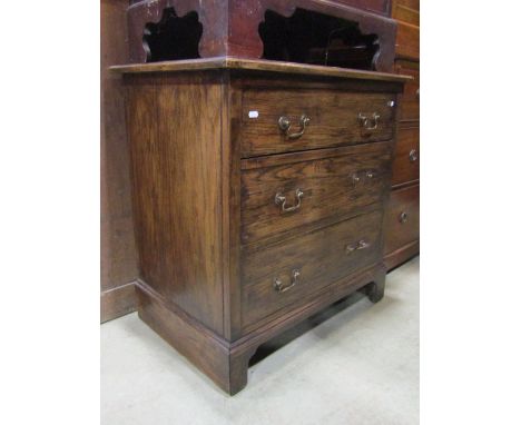 A small Edwardian/1920s oak bedroom chest of three long graduated drawers raised on bracket supports, 76 cm wide