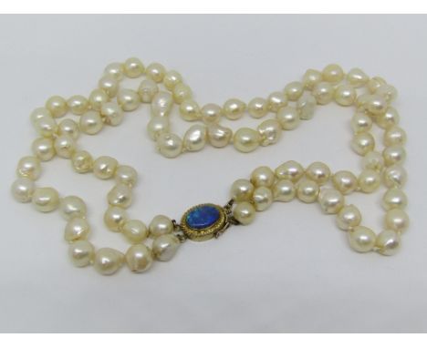 A double strand cultured pearl necklace with 14k oval clasp set with an opal triplet, pearls 1cm diameter approx, 41cm long a