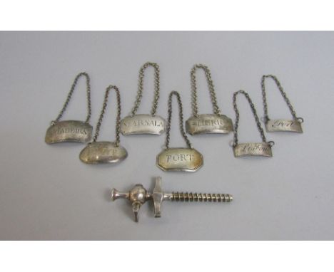 Collection of seven various silver and white metal decanter labels together with a white metal silver item (8)