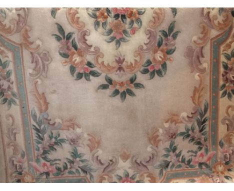 A Chinese washed wool carpet with pink ground with trailing floral panels and pastel shades, 240 x 150cm