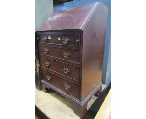 A small 19th century mahogany writing bureau, the fall flap enclosing a fitted interior of small drawers and pigeon holes and