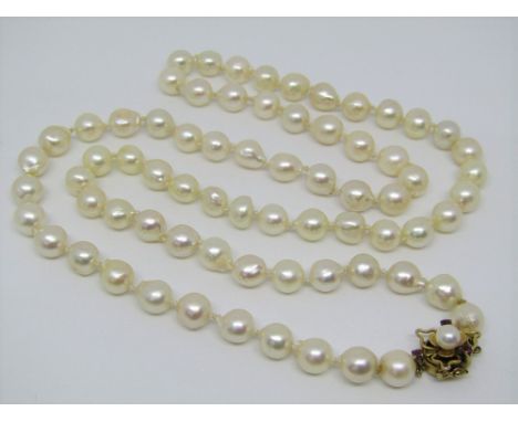 A cultured pearl necklace with 14k clasp of stylised trefoil design set with pink garnets, pearls 1cm diameter approx, 74cm l