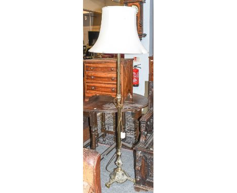 An Early 20th Century Brass Standard Lamp, with reeded support and shell cast base, 168cm overall