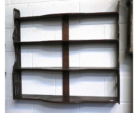 A Mahogany Four Tier Hanging Shelf, 19th century, with brass strung inlay, bow front mid section and having gothic style open
