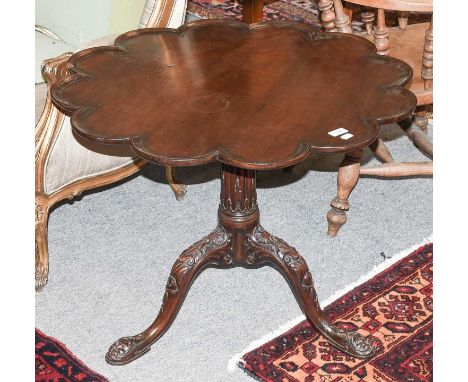 A 19th Century Mahogany Tripod Table, with shaped circular top,carved and reeded support and further carved legs, 80cm by 63c