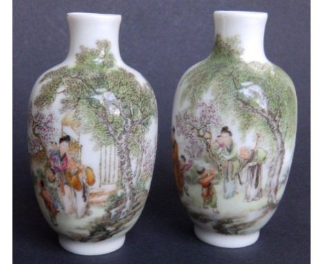 Two small Chinese 20thC porcelain vases, painted in detailed polychrome to show figures in conversation in a landscape - blue