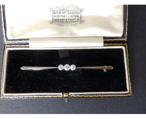 A three stone diamond set bar brooch/tie pin