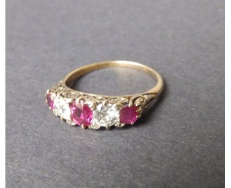 A five stone late Victorian graduated ruby & diamond ring in yellow gold