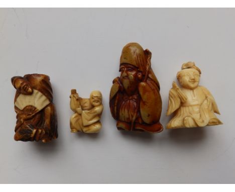 A small Japanese ivory netsuke study of a seated man together with three other netsukes (4)