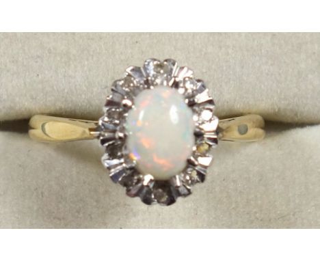 18ct gold ring set cabochon opal and 10 diamonds, London 1969, 4.1grs, cased (2) 
