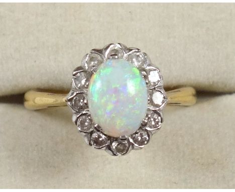 18ct gold ring set cabochon opal and 12 diamonds, by B &amp; S, London 1975, gross 3.9grs 