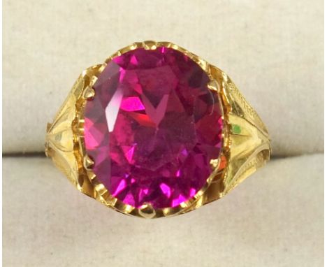 Chinese yellow metal ring set faceted oval pink coloured stone, gross 6.7grs 