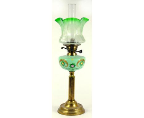 AN EDWARDIAN BRASS OIL LAMP, THE LIGHT GREEN GLASS FOUNT PAINTED WITH ROSES AND GILT, BRASS BURNER, WITH ART NOUVEAU GREEN TI