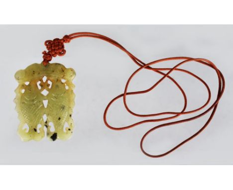 A LIGHT GREEN JADE PENDANT, carved with two fish.