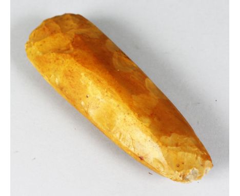 A NEOLITHIC FLINT AXE HEAD. 9ins long.