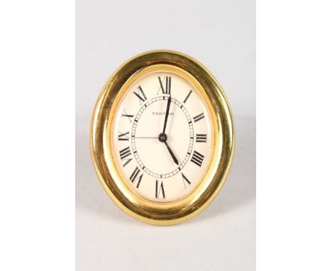 A GOOD CARTIER OVAL EASEL QUARTZ CLOCK, No. 890800215.  3.5ins high.