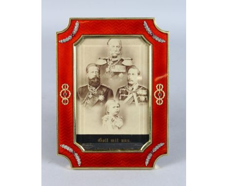 A SUPERB "FABERGE" RED ENAMEL AND SILVER GILT PHOTOGRAPH FRAME, set with precious stones. 8ins high, 5.5ins wide.