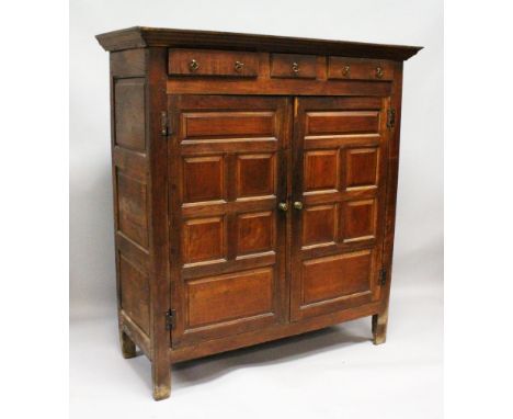 AN 18TH CENTURY OAK STANDING CUPBOARD with three small drawers over double panel doors, enclosing hanging space with one shel