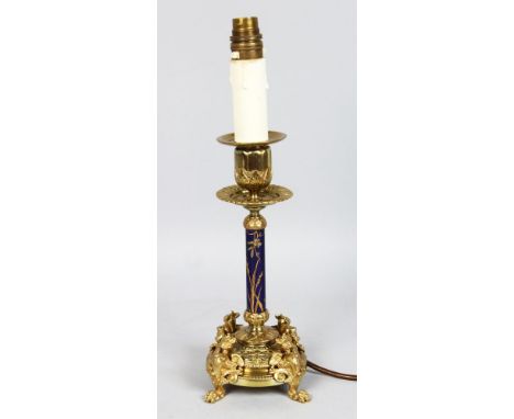 A 19TH CENTURY FRENCH BRASS AND PORCELAIN CANDLESTICK with dragon feet, converted to electricity.