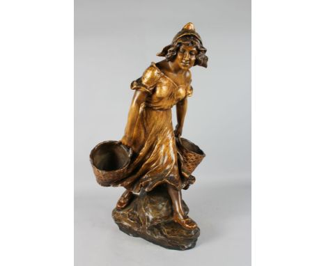 A LARGE GOLDSCHEIDER GILDED TERRACOTTA FIGURE OF A YOUNG GIRL carrying a basket. Signed.  25ins high.