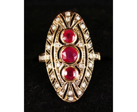 A 9CT YELLOW GOLD THREE ROUND CUT RUBY AND DIAMOND RING.