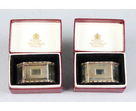 A PAIR OF MAPPIN & WEBB ENGINE TURNED SERVIETTE RINGS in original cardboard boxes.