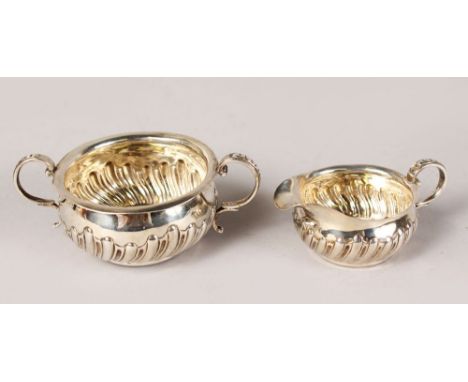 A SMALL VICTORIAN SEMI FLUTED TWO HANDLED SUGAR BASIN AND MILK JUG. London 1887.