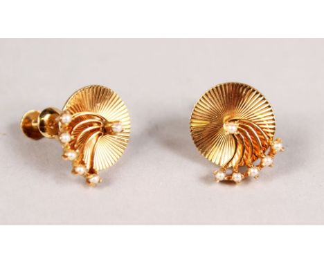 A PAIR OF EAR STUDS by CARTIER, each carved disc set with rotating swivel member and pear point in yellow gold, c. 1930's, ap