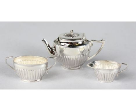 A THREE PIECE MINIATURE SILVER TEA SET.