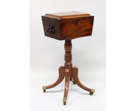 A REGENCY MAHOGANY TEAPOY, the top with fitted interior and glass mixing bowl, on a turned centre support ending in tripod le