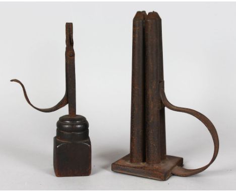 AN EARLY RUSH LIGHT HOLDER on a wooden base, 5.5ins high, and an unusual four candle mould with handle on a square base, 10in