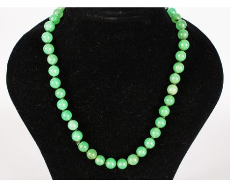 A GREEN JADE NECKLACE.