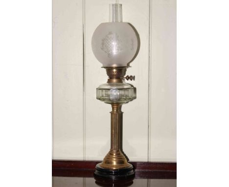 Brass reeded column oil lamp with clear glass reservoir and frosted and etched glass shade.