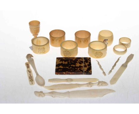 Collection of vintage ivory napkin rings, some carved, bone letter openers, and tortoiseshell card case.