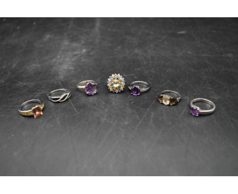 A collection of seven gemset silver rings. Including amethyst, topaz, black diamond and other gemstones. 