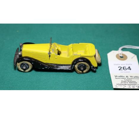 A rare Dinky Toys Sports Tourer Four Seater (24g). Bright yellow body with spare wheel carrier to rear, original open tinplat