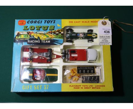 A Corgi Toys Gift Set 37 "Lotus Racing Team". Comprising a Lotus Climax Racing Car in BRG with yellow stripe, RN1, Lotus Elan