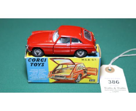 Corgi Toys M.G.B. G.T. (327). In deep red with pale blue interior, spoked wheels, complete with case in the boot. Boxed, 8.5/