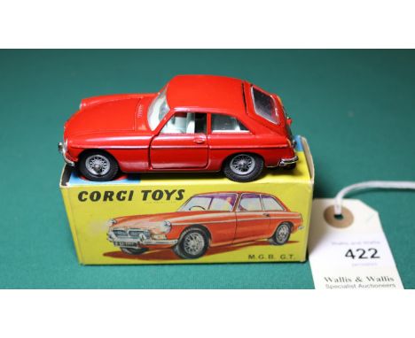 Corgi MGB GT (327). In deep red with mid blue interior, spoked wheels and black tyres. Complete with black suitcase. Boxed 9.