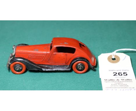 Dinky Toys 24 Series Super Streamlined Saloon 24e. An example in red with black 'criss-cross chassis, with the the rare origi