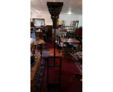 An early 20th century Chinese hardwood adjustable standard lamp, with pierced and carved decoration 